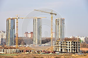 View of a large construction site. Tower cranes in action. Housing renovation concept. Crane during formworks. Construction the