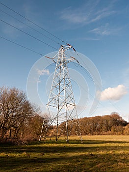 view of large electrical wire metal pylon outside in nature field