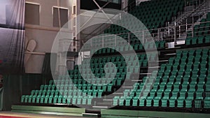 View of large empty grand concert hall with bright green seats, iron fence. Interiors. Nobody.