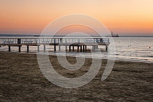 View of the Larnaca sandy beach at sunrise, tourist resort, Cyprus. Scenic seascape, travel background, summer holidays concept
