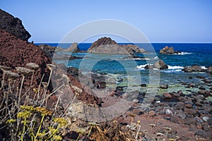 View of the lava beach of Linosa Called Faraglioni, Sicily. Italy