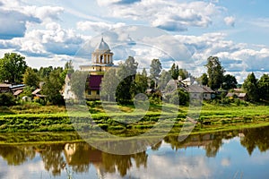 View of the left bank of the river Msta and the Church of the Assumption of the Blessed Virgin Mary