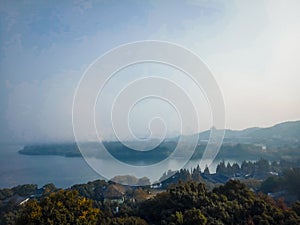 View from Leifeng Pagoda Hangzhou West Lake autumn scenery .mountain range at sunrise sunset orange sky beautiful landscape .