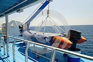 View of a lifeboat on the deck of a cruise ship.