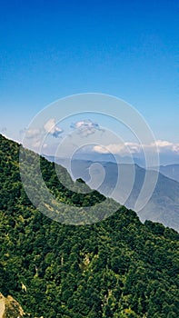 View from the lift to the mountains, forest, clouds