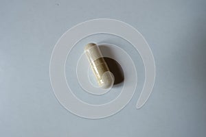 View of light beige capsule of Saccharomyces boulardii probiotic from above