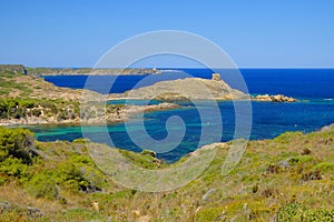 View on the light house Cape Favaritx and the old watch tower Es Colomar in Es Grau on Menorca