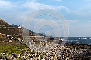 View of the lighthouse of cabo silleiro and the rocky coast. Galicia - Spain photo