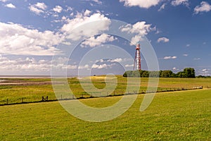 View on the lighthouse of campen near emden, north sea, germany