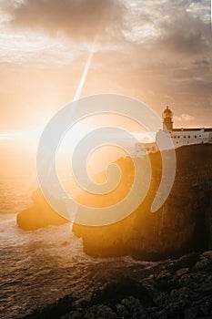 View of the lighthouse and cliffs at Cape St. Vincent in Portugal at sunset.