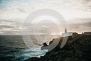 View of the lighthouse and cliffs at Cape St. Vincent in Portugal at sunset.