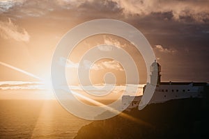 View of the lighthouse and cliffs at Cape St. Vincent in Portugal at sunset.