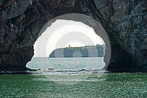 View of lighthouse through the hole in Perce Rock