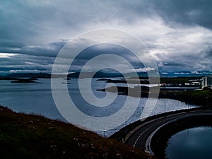 View from the Lighthouse island of StykkishÃ³lmur, Iceland with couldy weather on the ocean and a road