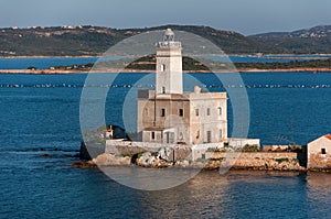 A view of lighthouse in Olbia gulf on sunset hour