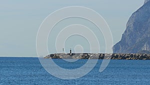 View of the Lighthouse by the Sea near the Rock of Gibraltar. Spain.