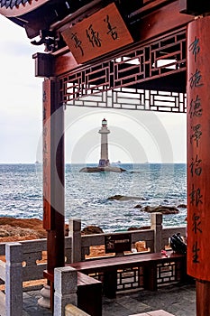 View of the lighthouse in the sea near the rocky shore. End of the World Park, Sanya, China