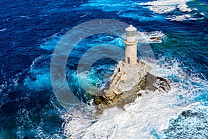 View of the Lighthouse Tourlitis during strong waves. Andros island, Greece