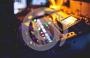 View of lighting technician operator working on mixing console workplace during live event concert on stage show broadcast, light