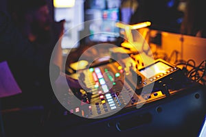 View of lighting technician operator working on mixing console workplace during live event concert on stage show broadcast, light