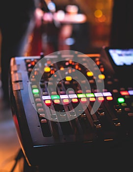 View of lighting technician operator working on mixing console workplace during live event concert on stage show broadcast, light