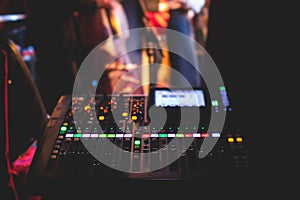 View of lighting technician operator working on mixing console workplace during live event concert on stage show broadcast, light