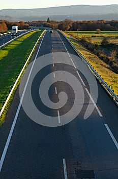view of a lightly trafficked highway at dusk, background for transport concept photo