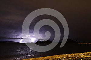 View of lightning strike over a rural farm field, lightning strikes the ground,