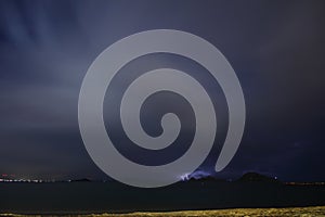 View of lightning strike over a rural farm field, lightning strikes the ground,