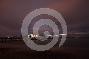 View of lightning strike over a rural farm field, lightning strikes the ground, strong thunder, lightning, dark clouds in the sky