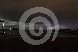 View of lightning strike over a rural farm field, lightning strikes the ground, strong thunder, lightning, dark clouds in the sky