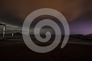 View of lightning strike over a rural farm field, lightning strikes the ground, strong thunder, lightning, dark clouds in the sky