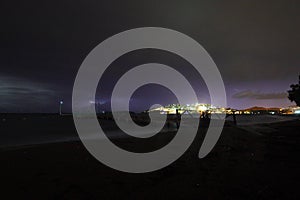 View of lightning strike over a rural farm field, lightning strikes the ground, strong thunder, lightning, dark clouds in the sky