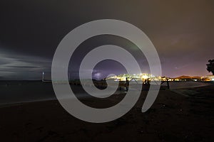 View of lightning strike over a rural farm field, lightning strikes the ground, strong thunder, lightning, dark clouds in the sky