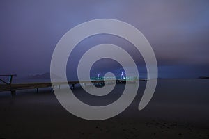 View of lightning strike over a rural farm field, lightning strikes the ground, strong thunder, lightning, dark clouds in the sky