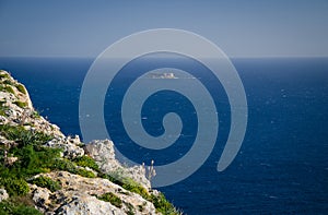 View of limestone rock, Mediterranean sea and Filfla island, Malta