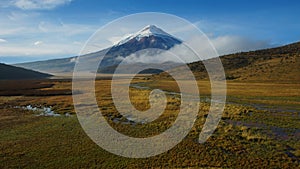 View of Limpiopungo lagoon with volcano Cotopaxi in the background on a cloudy morning