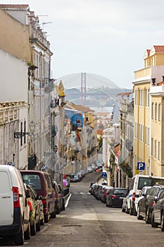 A view of Lisbon`s downtown cityscape with the Tagus river and the bridge `25 de abril` in the background