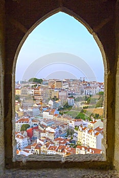 View of Lisbon from St Georges Castle, looking through the window over the city.Colorful buildings, houses blue and