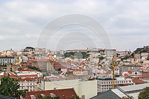 View of the Lisbon from the viewpoint Miradouro de Sao Pedro de Alcantara. Sightseeing In Portugal. Orange roofs of the old town