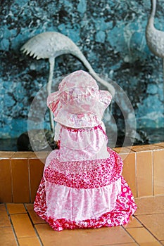 View of little girl in nice pink dress and a hat