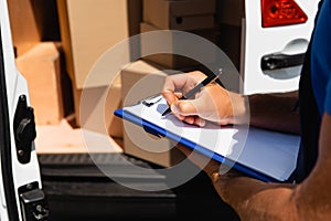 View of loader writing on clipboard