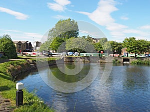 a view of the lock entrance to brighouse basin with moored houseboats on the calder and hebble navigation canal in calderdale west