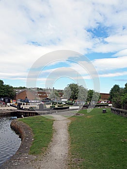 a view of the lock entrance to brighouse basin and moorings on the calder and hebble navigation canal in calderdale west yorkshire