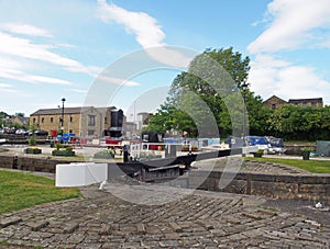 A view of the lock gates at the entrance to brighouse basin and moorings on the calder and hebble navigation canal in calderdale