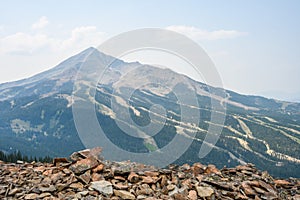 View of Lone Mountain peak and sky runs, in the summer, from the peak across the valley, Big Sky, Montana photo