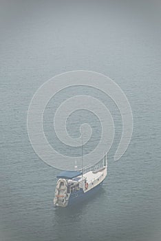 View on lonely boat and Lake Baikal under the fog