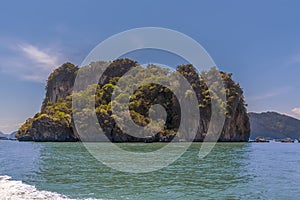 A view from a longtailed speed boat in Phang Nga Bay towards a large island in Thailand photo