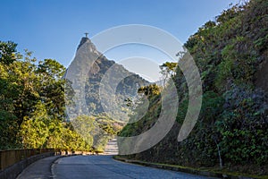 View down a road in Tijuca forest with Christ the Redeemer on top of Mount Corcovado in Rio de Janeiro, Brazil, South America