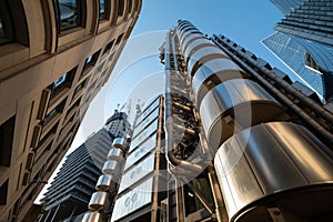 View looking skywards on Lime Street, London UK, with the iconic Lloyds of London building in the foreground. photo